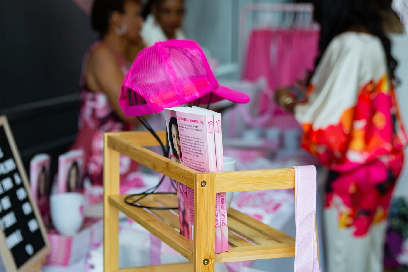 A coordinated pink celebration display with styled books and accessories